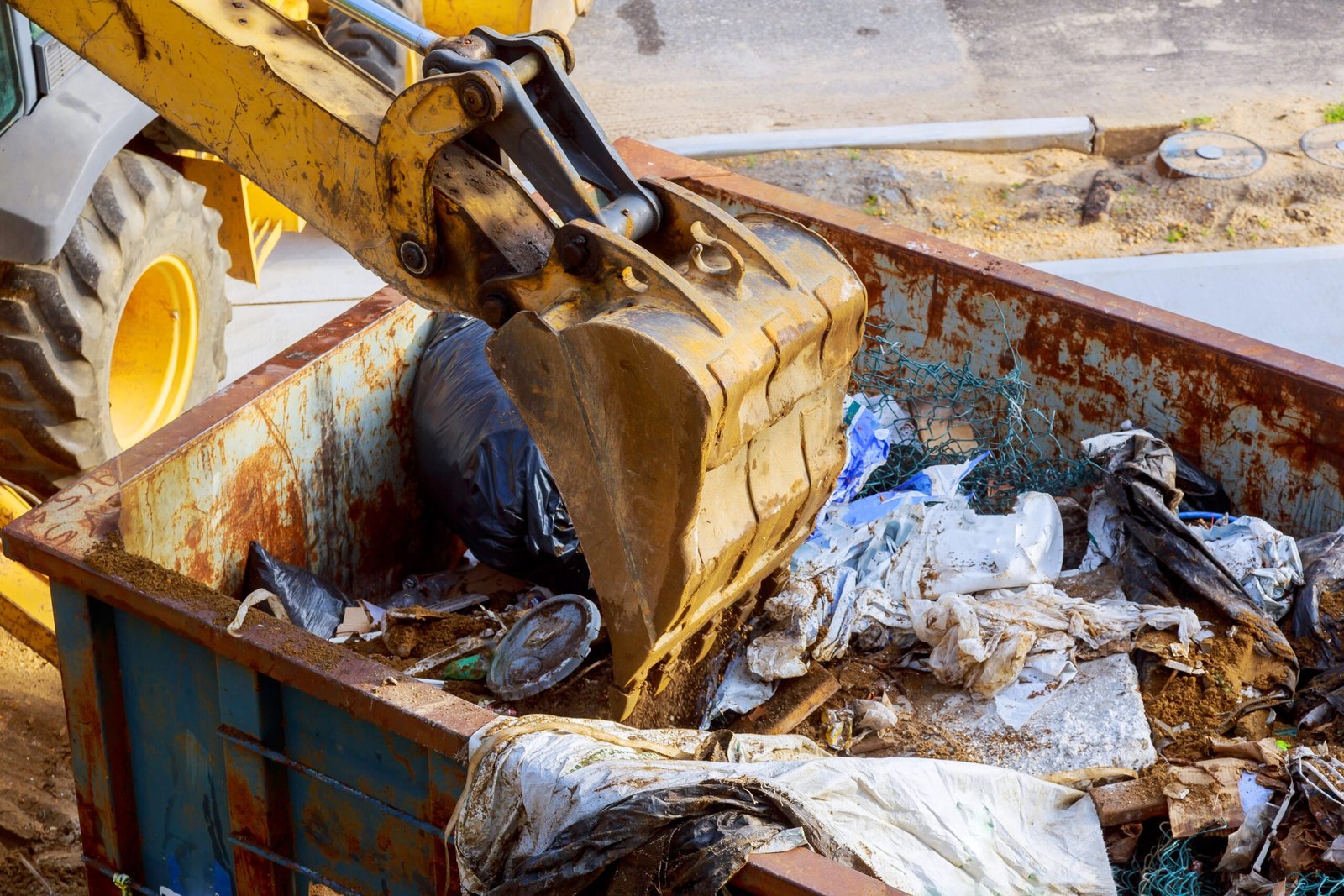 wheel material handler dumping refuse disposal with excavator shovel construction site